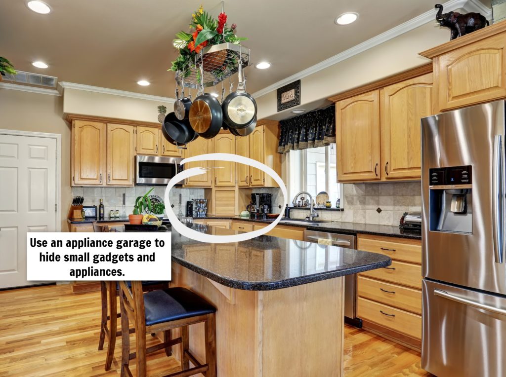a view of a neat kitchen with a pot rack in the center copy 