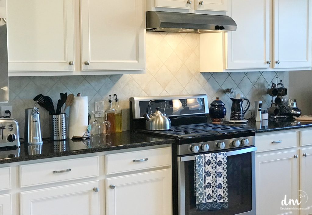 a white kitchen with small appliances on the counters