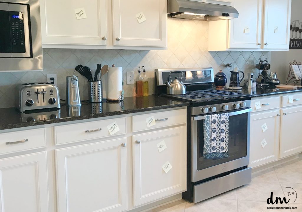 a white kitchen with sticky notes telling where zones are located