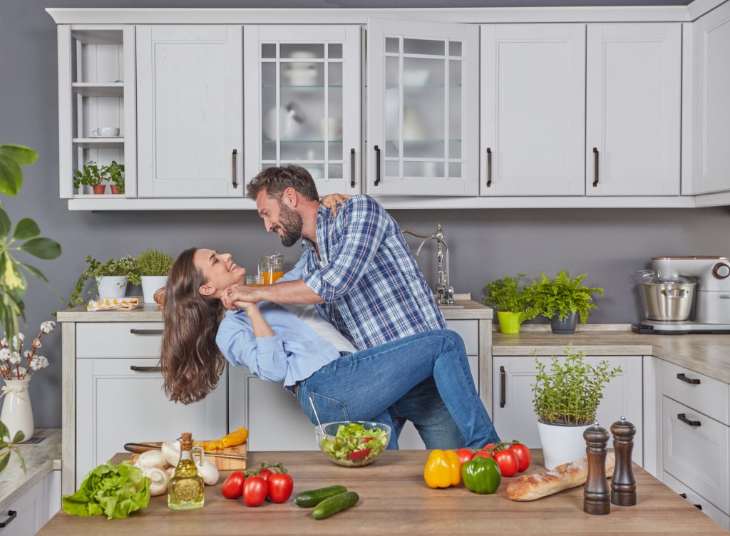 young couple dancing in a small kitchen
