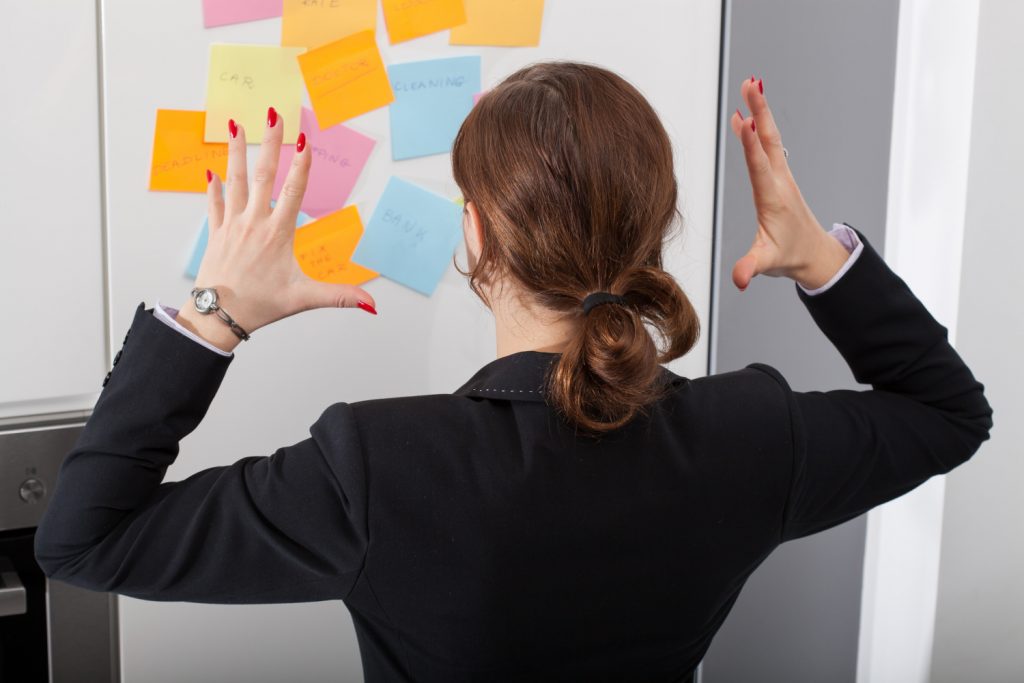 women looking at numerous post it notes frustrated