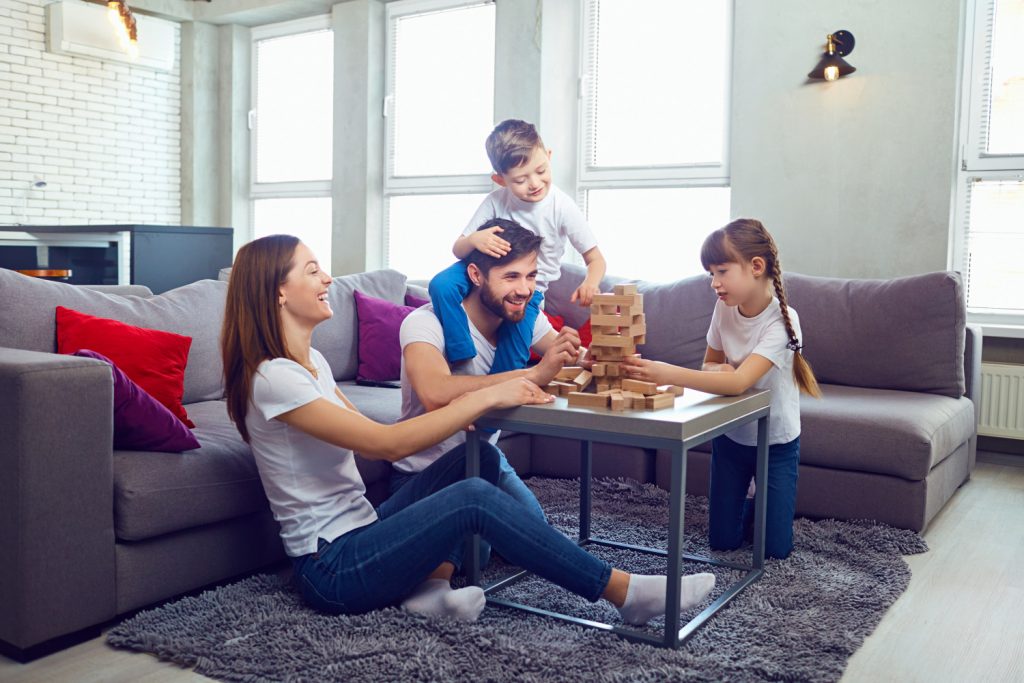 family playing a game. Easy decluttering tips for a clutter free home.