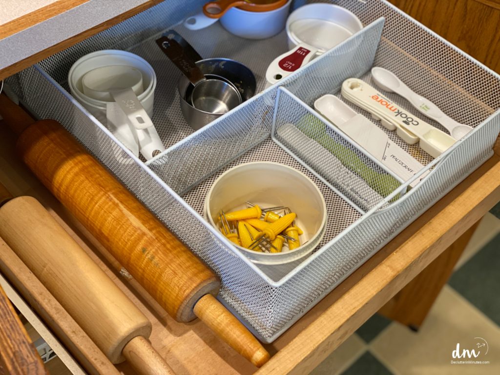 an organized drawer in a kitchen of measuring cups and spoons