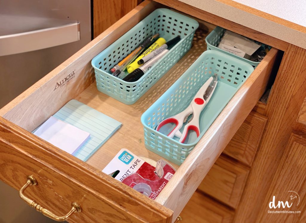 baskets in a drawer of a kitchen that hold office supplies