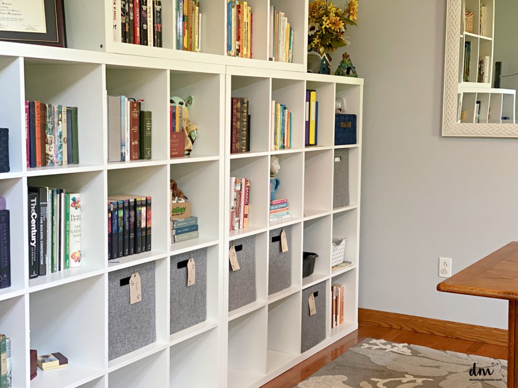 bookshelves filled with books and baskets 
