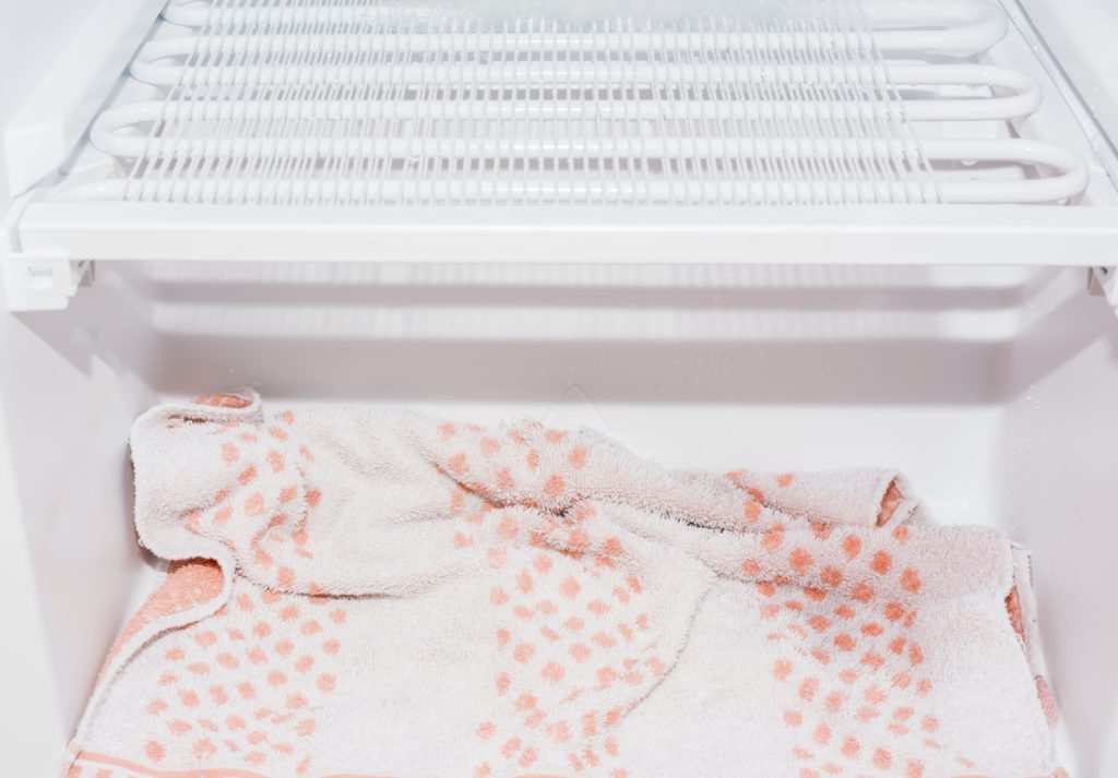 a towel in a freezer that is defrosting