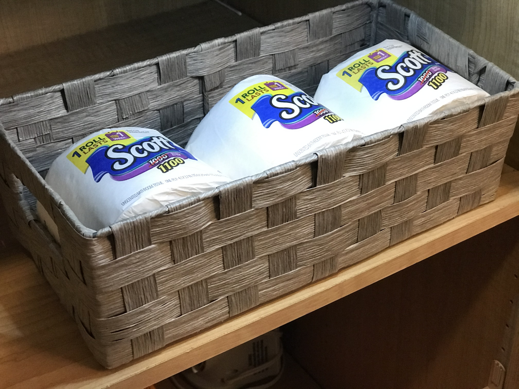 a basket filled with toilet paper in a bathroom