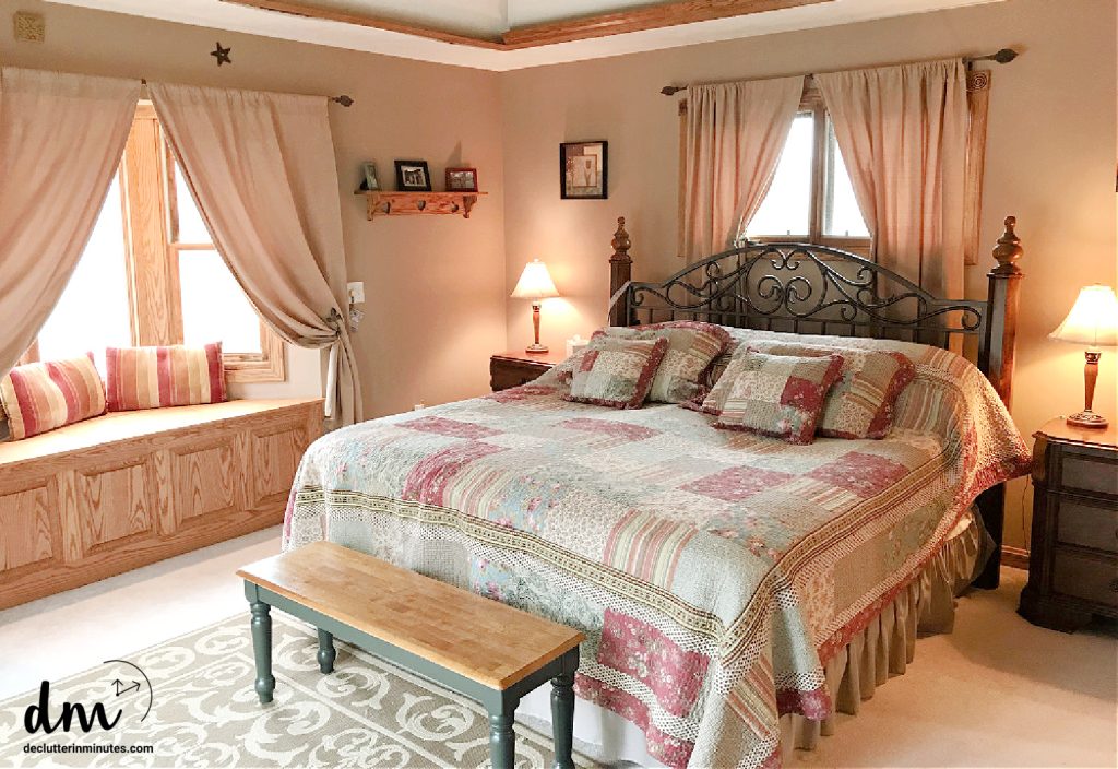 a bed in a room with a window seat and bench