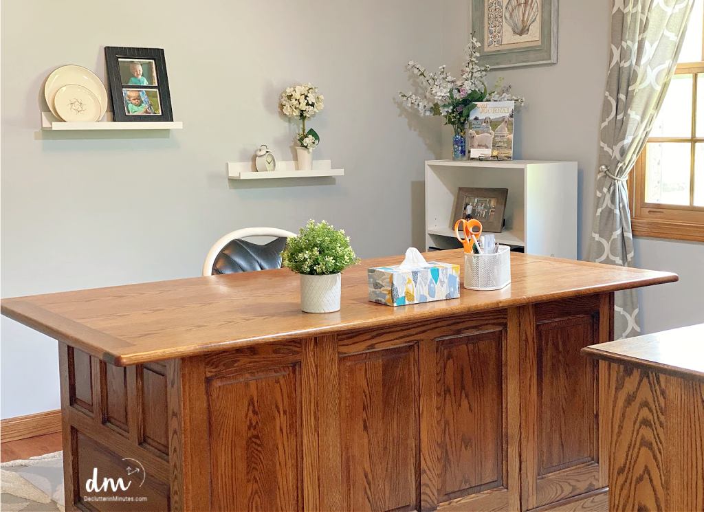 brown desk with a green plant in a home office