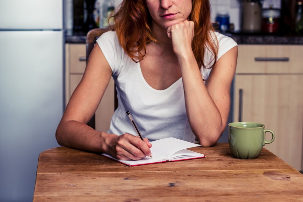 woman writing up a morning routine