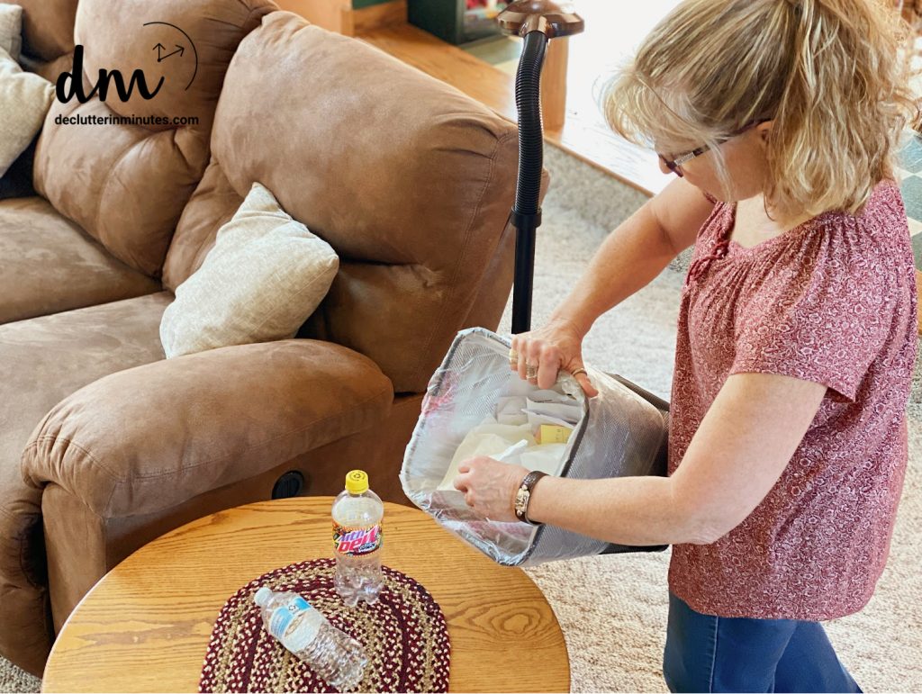 woman gathering up trash and clutter