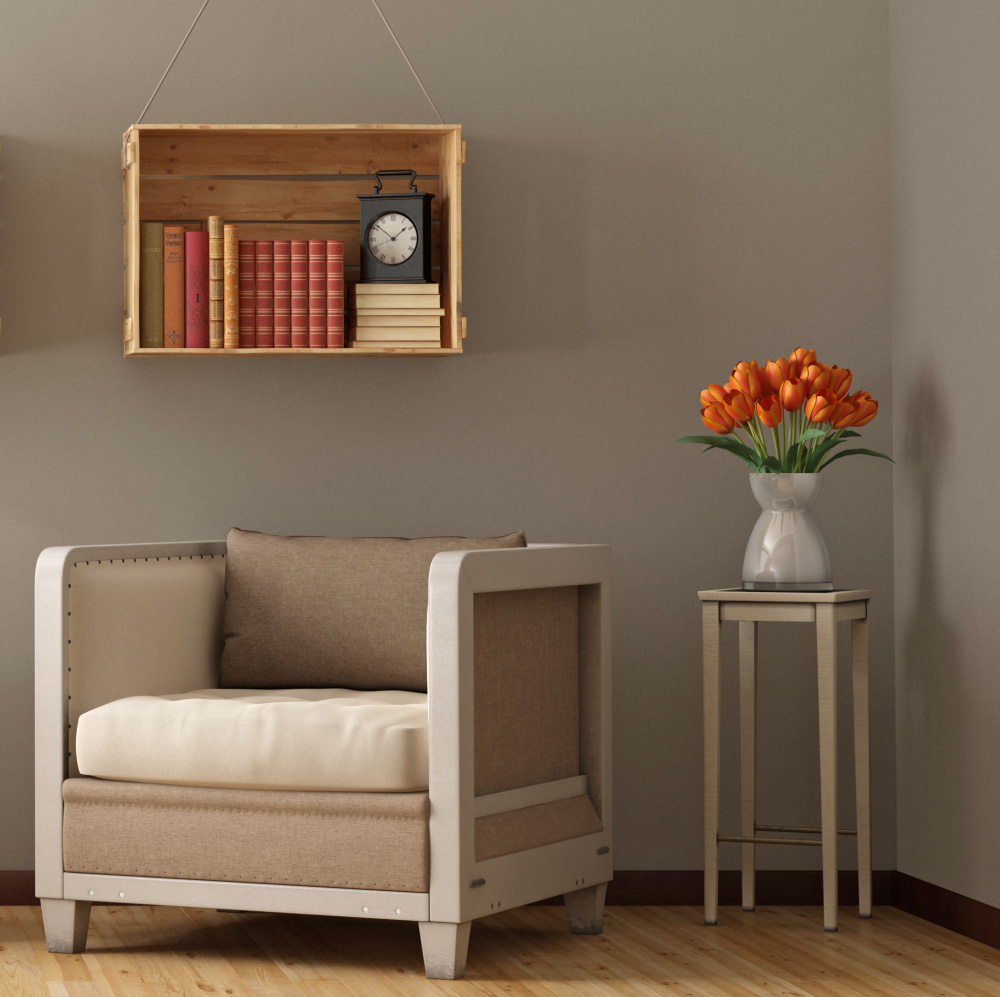 wooden crate with books stored inside hanging on a wall over a tan chair