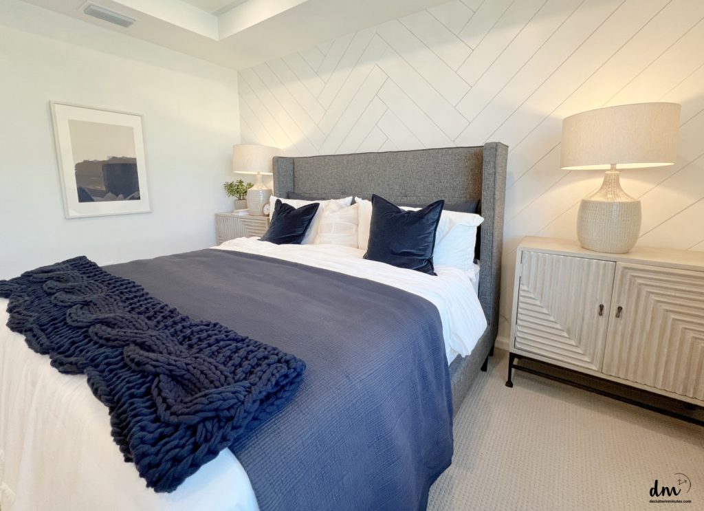 a navy and white bed in a bedroom