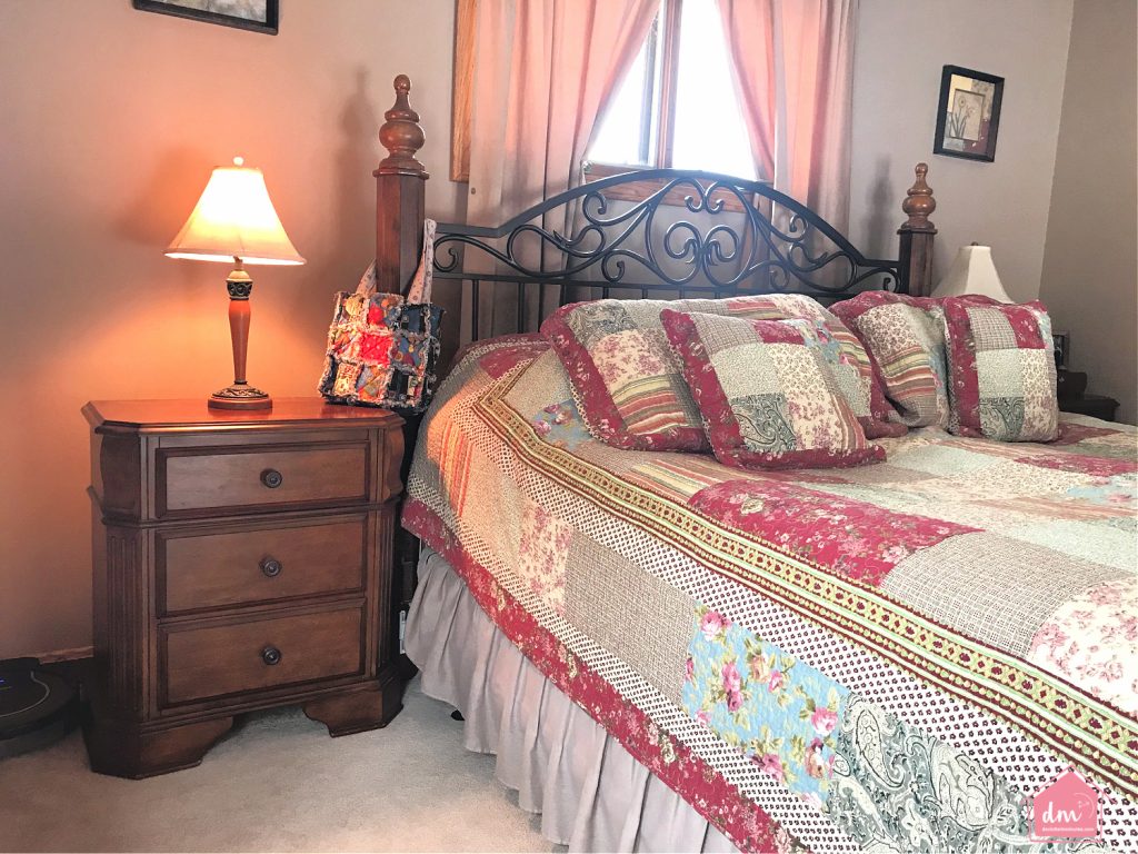 nightstand next to a bed