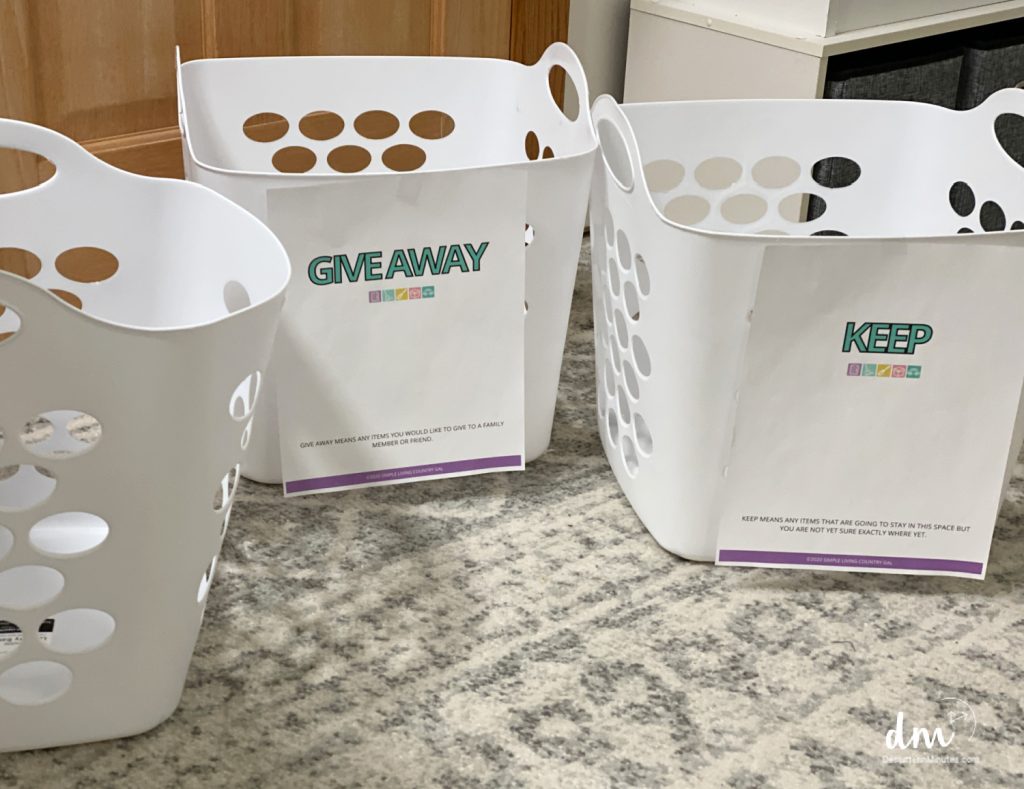 white baskets with labels for sorting clutter into