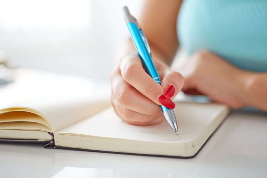 woman checking her to-do list with her calendar
