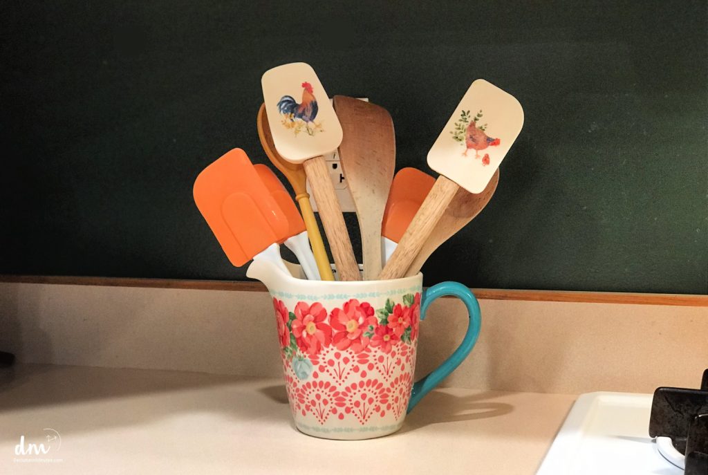 Spatulas in a crock on a kitchen counter