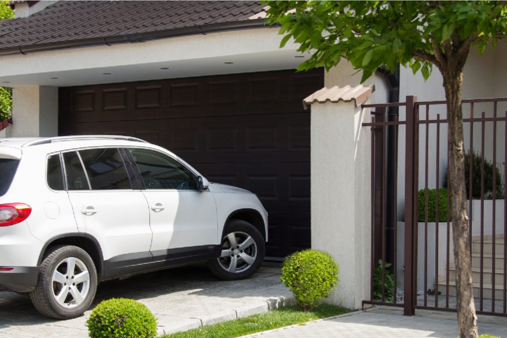 a car sitting outside of an organized garage