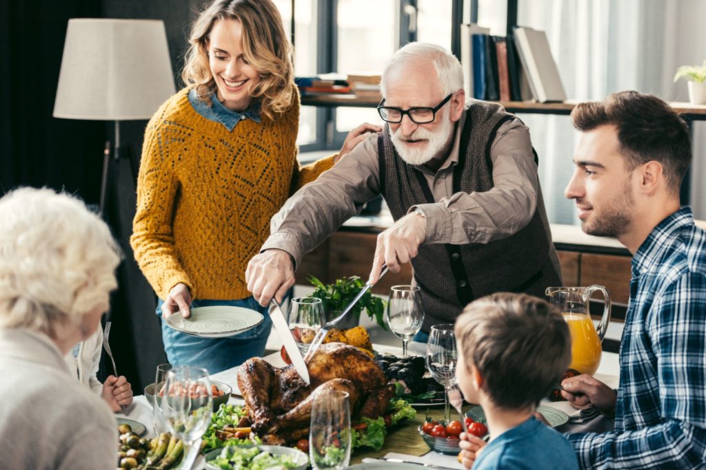 A family sitting down to thanksgiving dinner