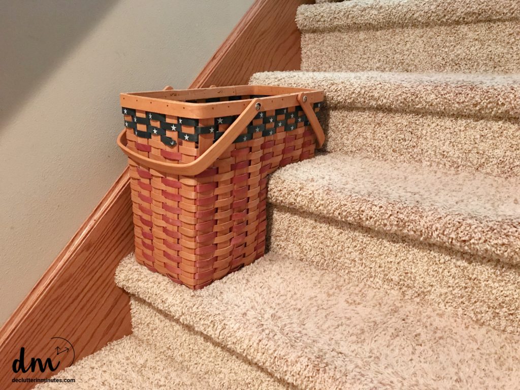 a basket on the stairs to hold items that need to be put away