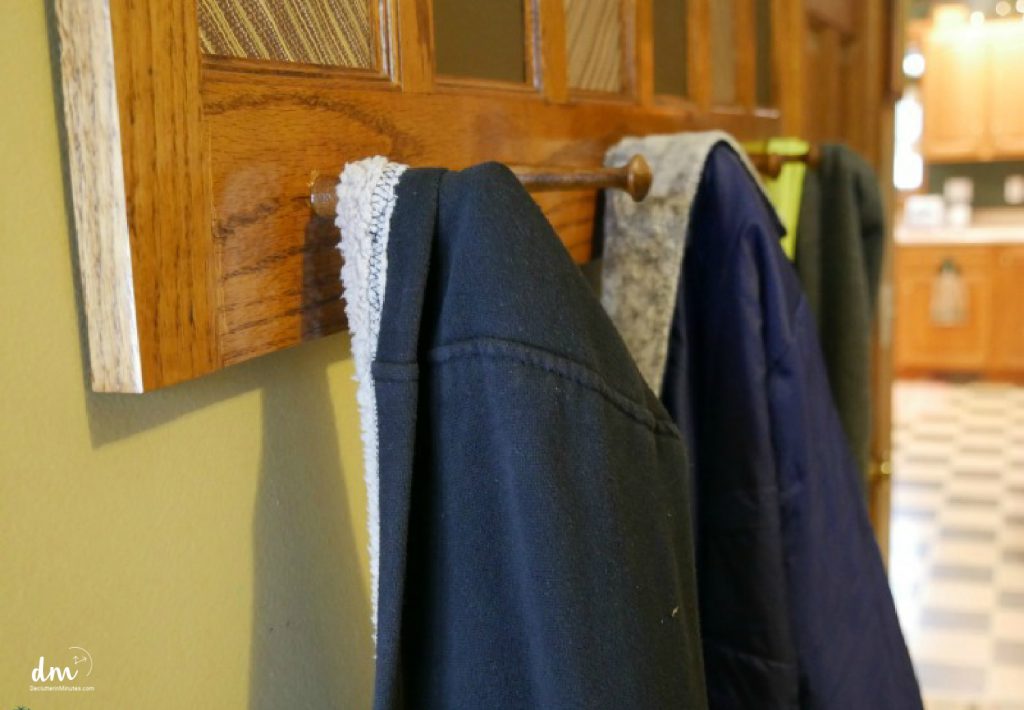 coats hanging on hooks in mudroom