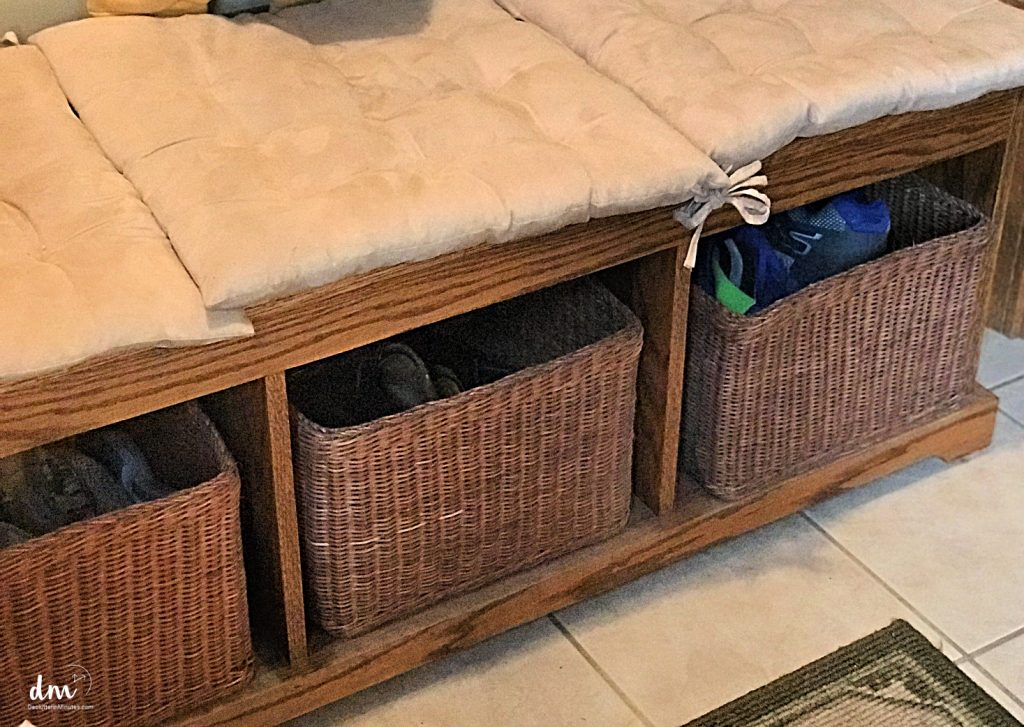 shoe baskets under a bench in mudroom