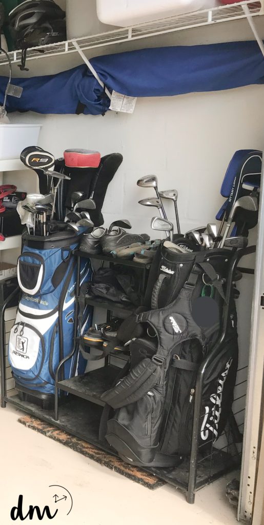 golf equipment on a organizer in a garage