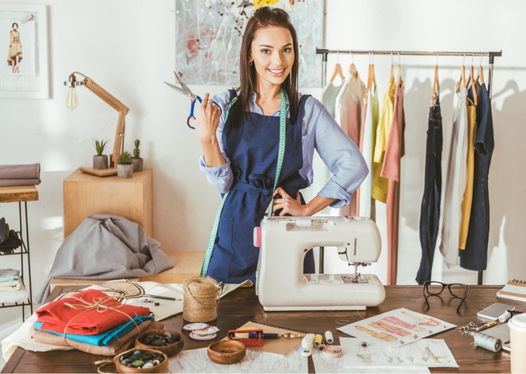 a woman holding scissors in a sewing room