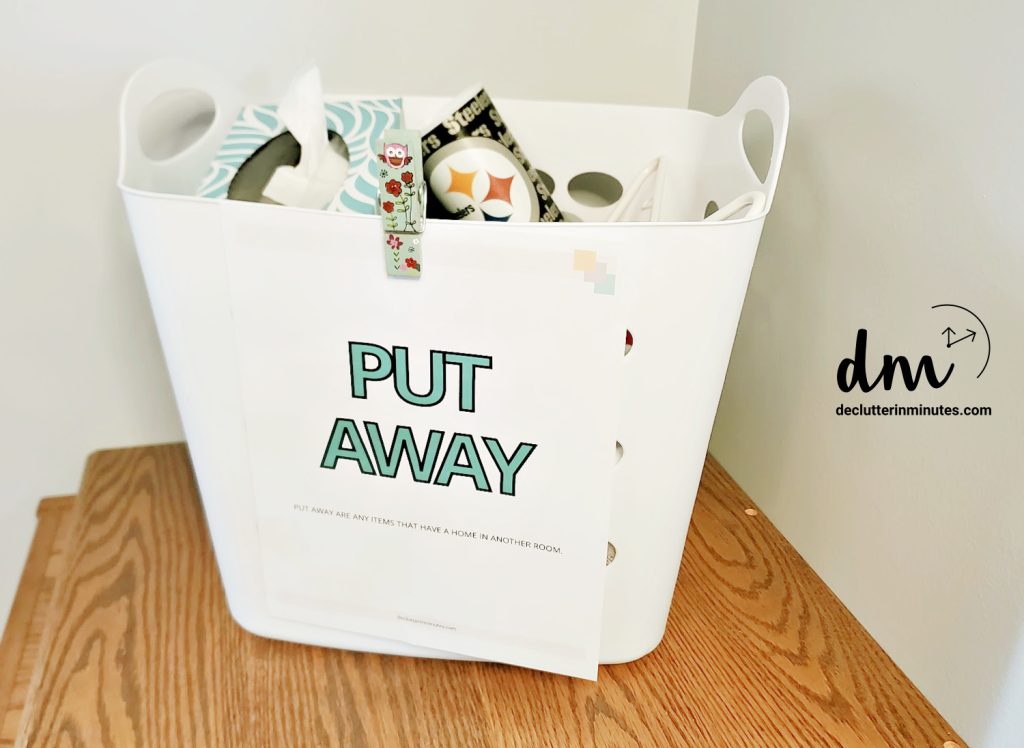 basket of random things with a put away sign on the front copy