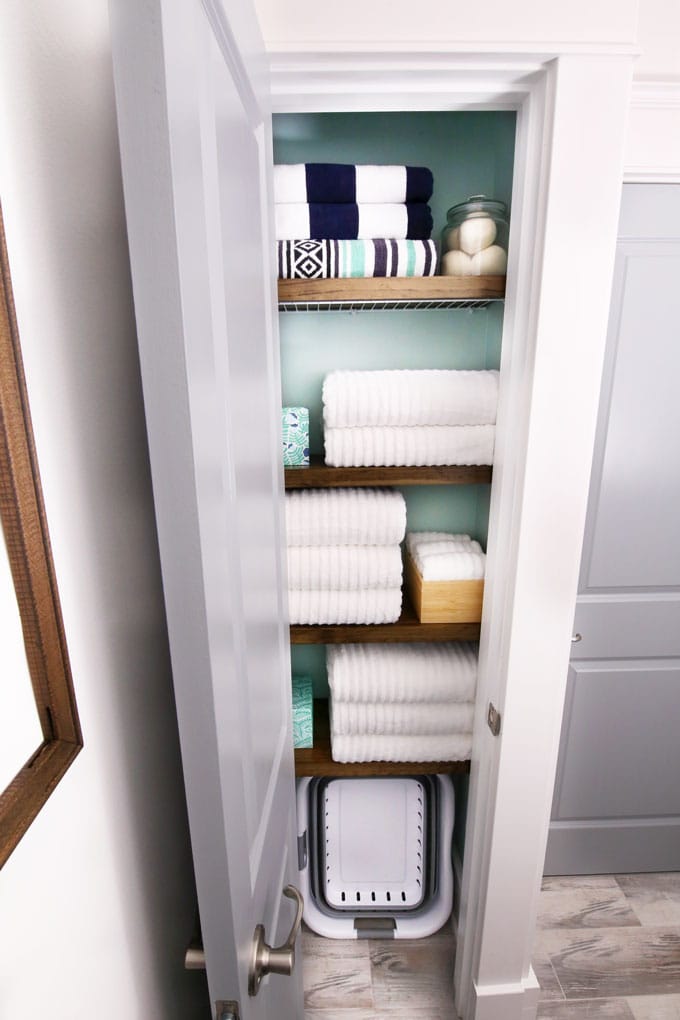organize narrow linen closet