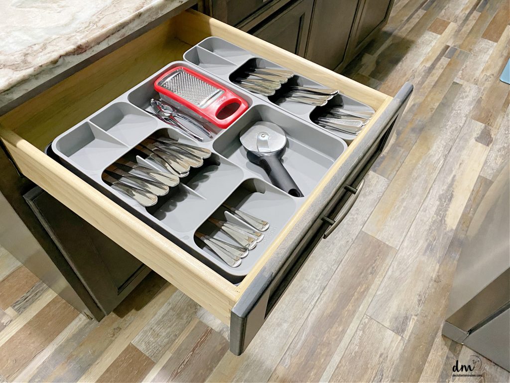 a neat and organized silverware drawer in a kitchen