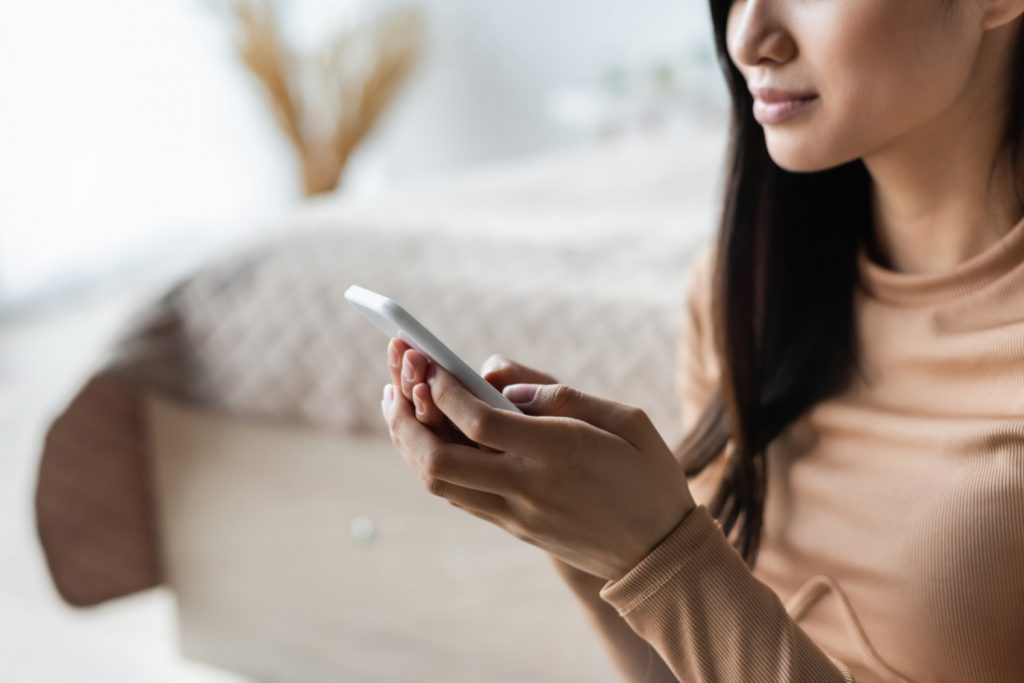 woman typing on her phone