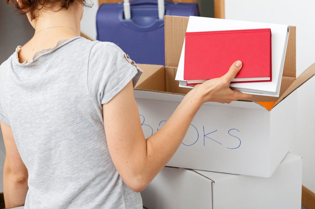 woman packing books into a donation box