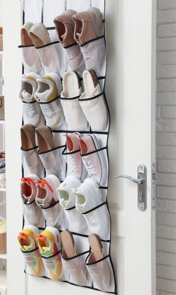 shoes handing on the inside of a closet door