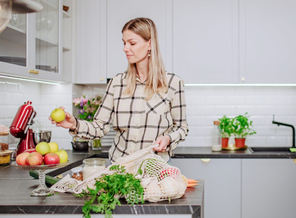 a woman unpacking bags of groceries
