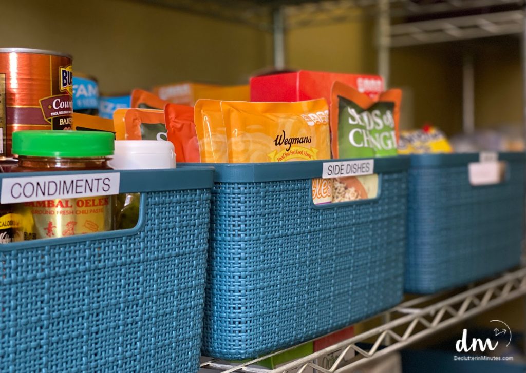 blue baskets on a pantry shelf labeled condiments and side dishes