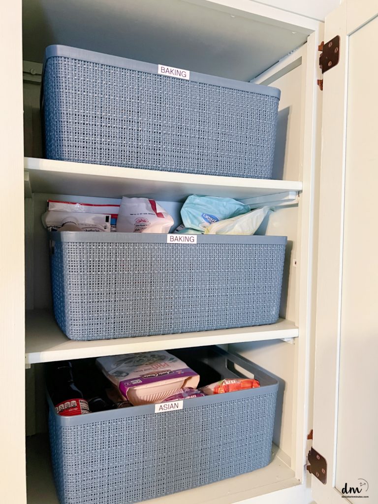 jute bins that are labeled in a kitchen pantry