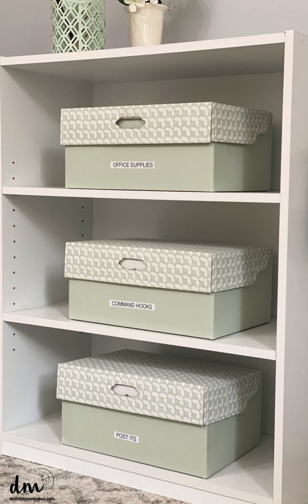3 boxes in an office labeled and on a white bookshelf