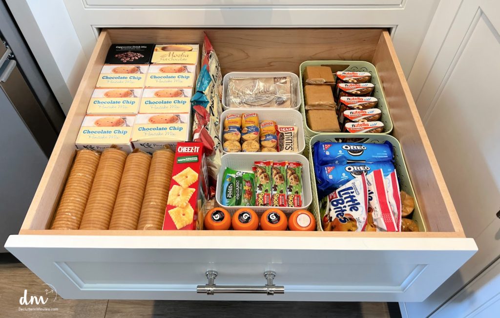 a drawer full of snacks organized in bins.