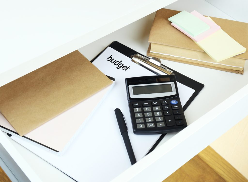 Office supplies in open desk drawer close up