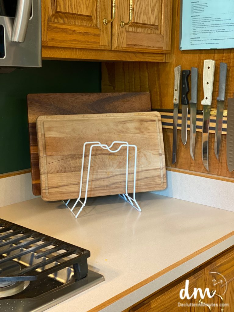 a file organizer on a kitchen counter holding cutting boards
