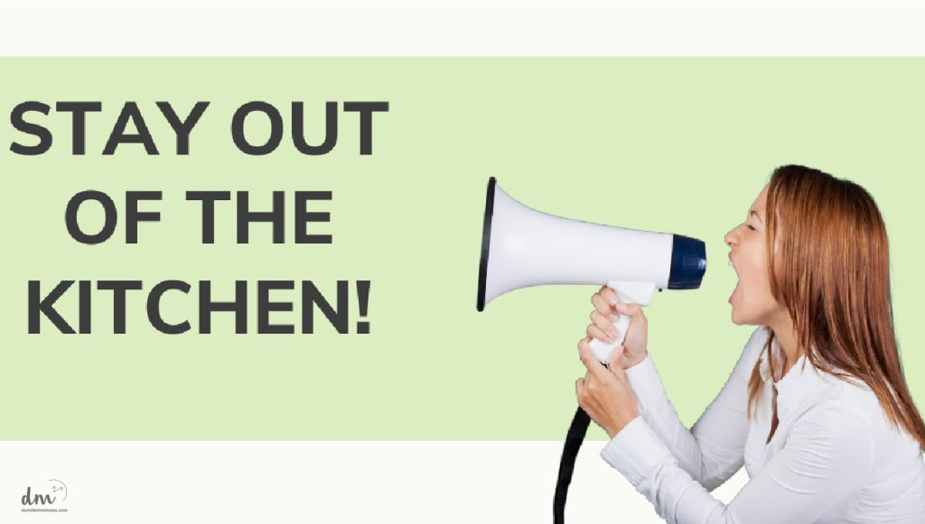 A woman shouting into a megaphone with the text "STAY OUT OF THE KITCHEN"
