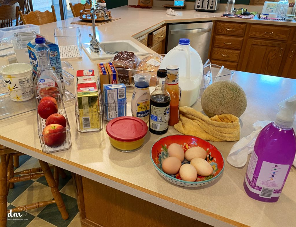 random items on a kitchen counter from the refrigerator being sorted