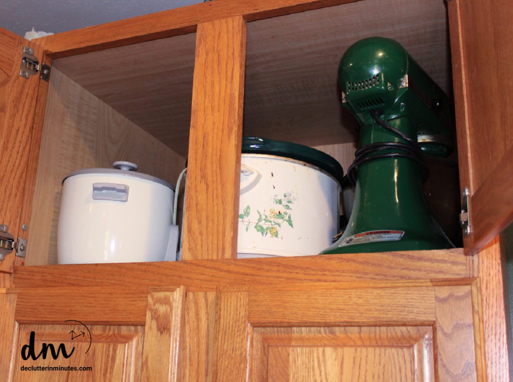 small appliances in an upper cabinet of a kitchen