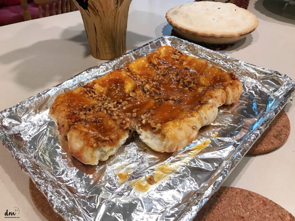 sticky buns on a tray next to a pie