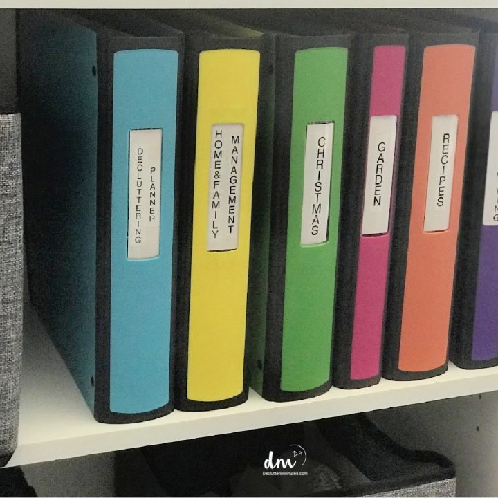 white shelf with colored binders stored on a shelf