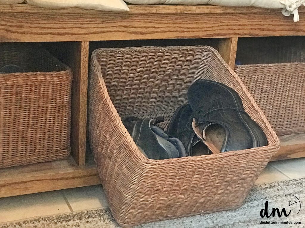 a basket of shoes in a bench of a mudroom