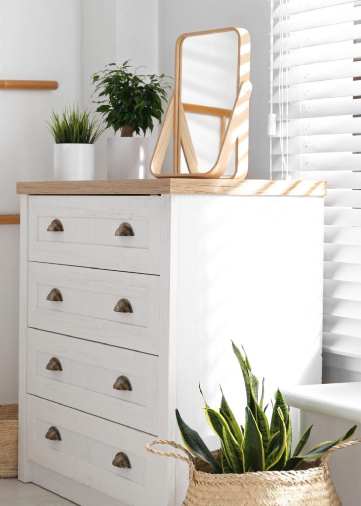 a white chest of drawers in a bedroom