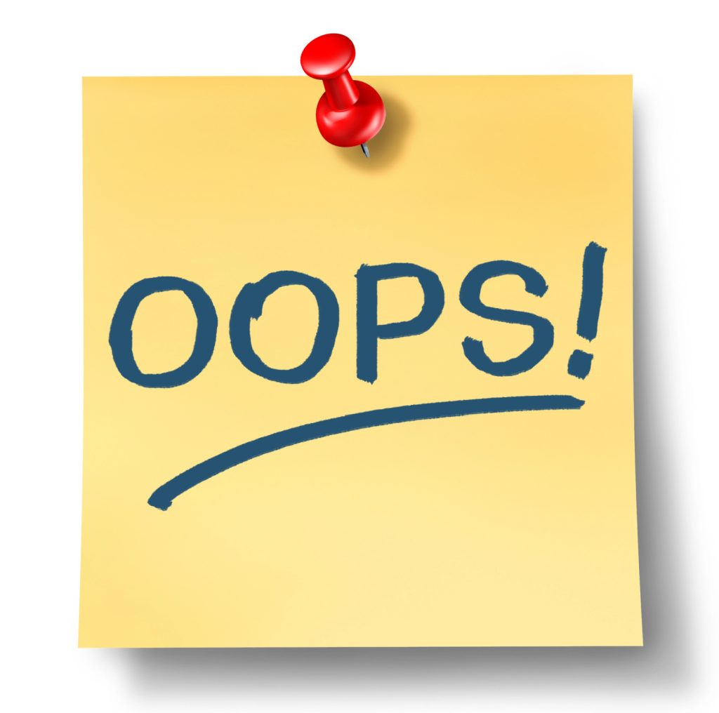 oops on a sticky note with a red push pin