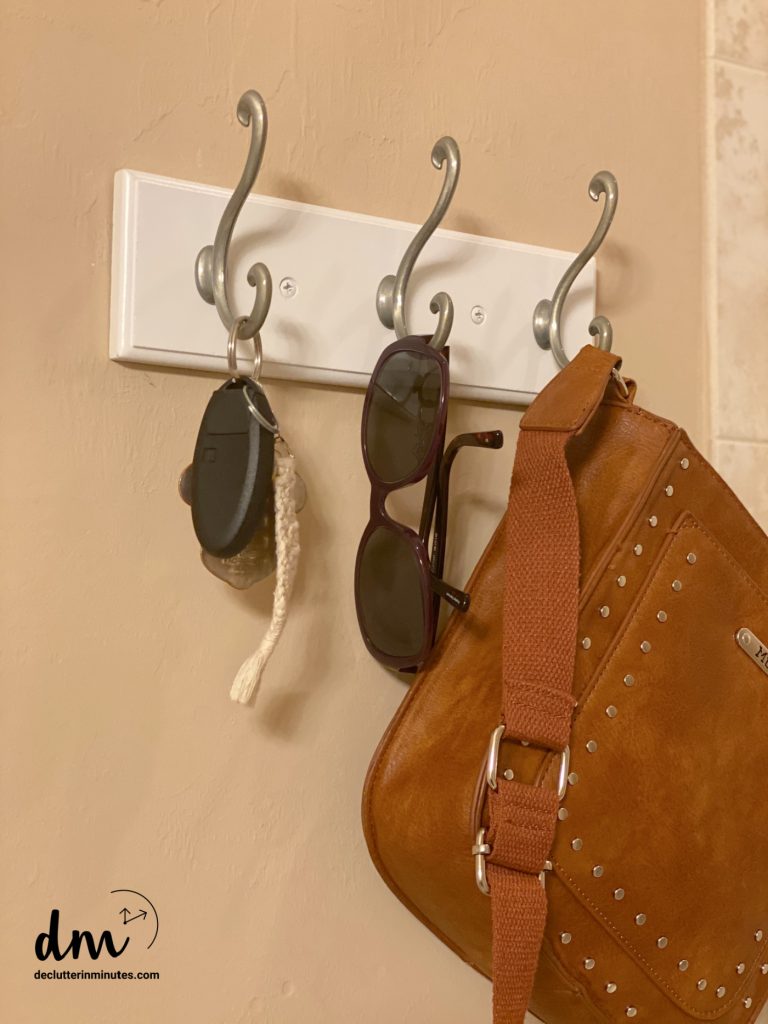 purse, keys, glasses hanging on a hook system in a mudroom